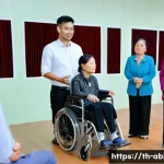 Home 22 장애인상담사 커리어 발전 - A professional workshop scene in a modern Thai community center, showing a diverse group of disabled...